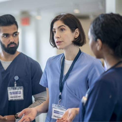 Three doctors in a professional conversation. 